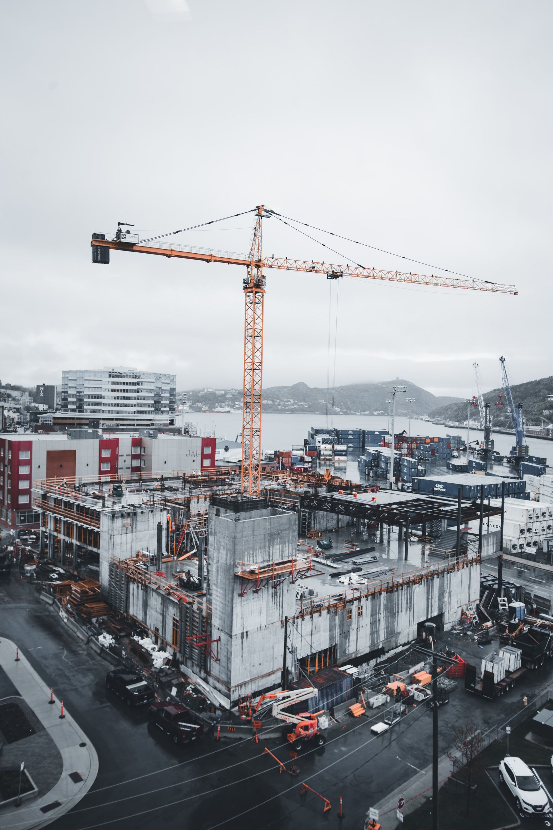 Elevated reference photograph of a large construction project and tower crane.